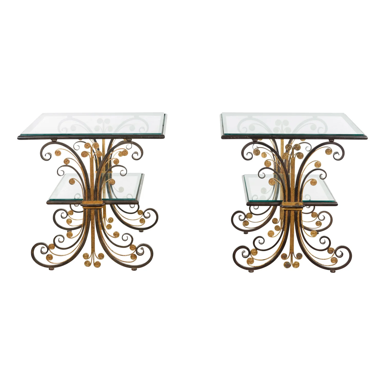 Pair of scrollwork and glass tables photographed symmetrically