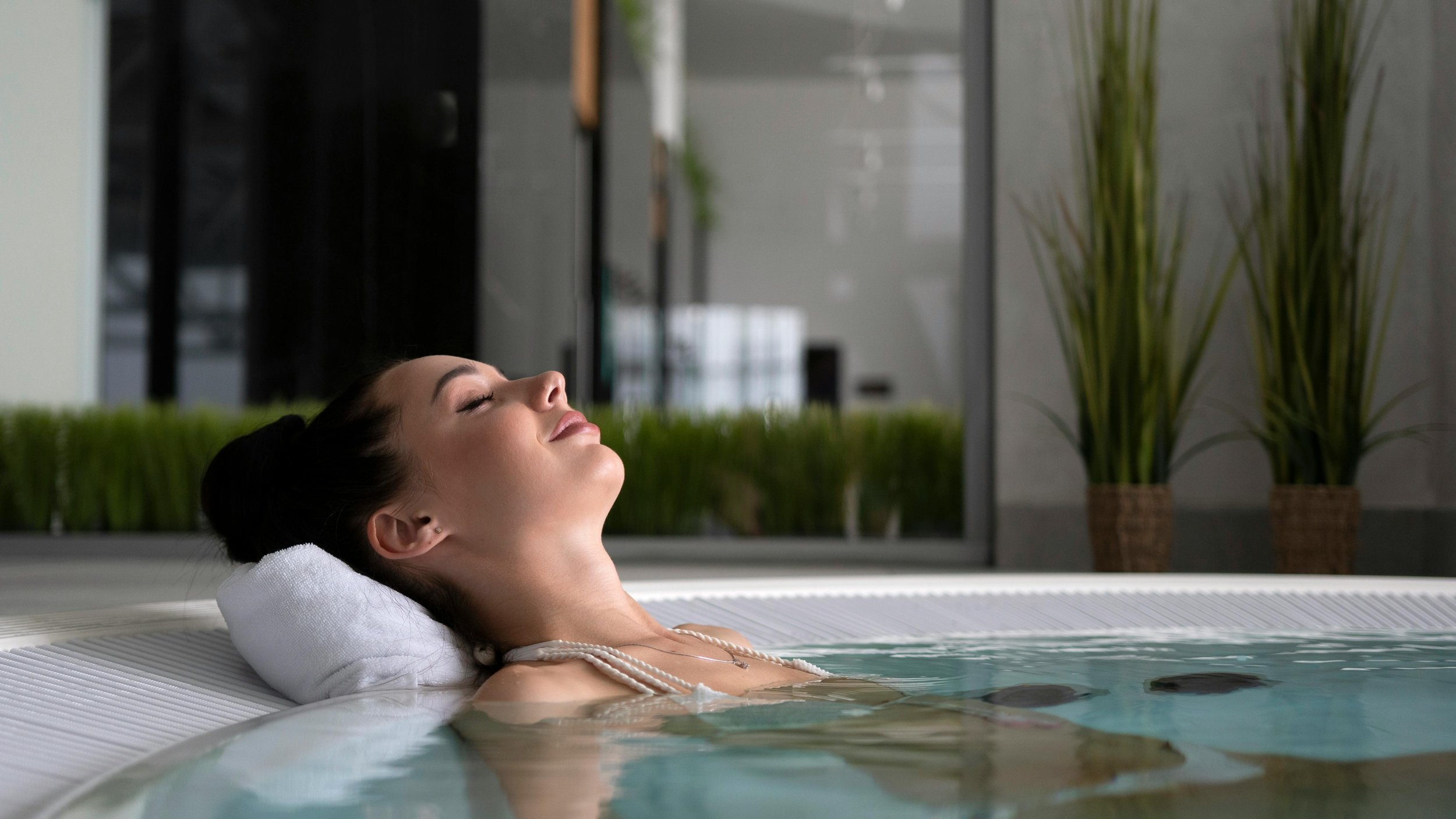 Woman relaxing with eyes closed during a spa or hot tub session