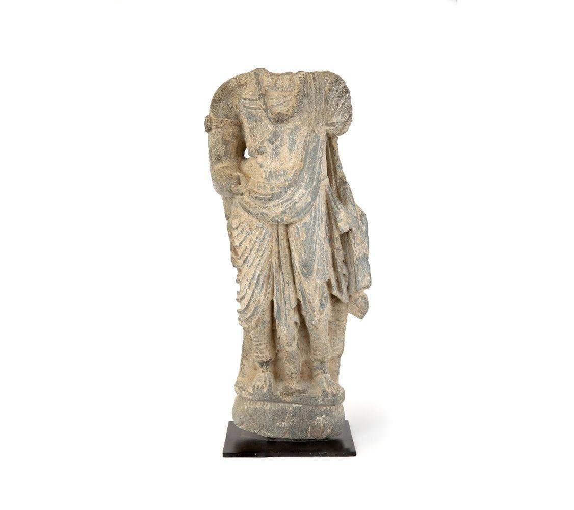 A large fragmentary Gandharan schist figure of a bodhisattva, possibly Maitreya. Afghanistan, 100-200 C.E.