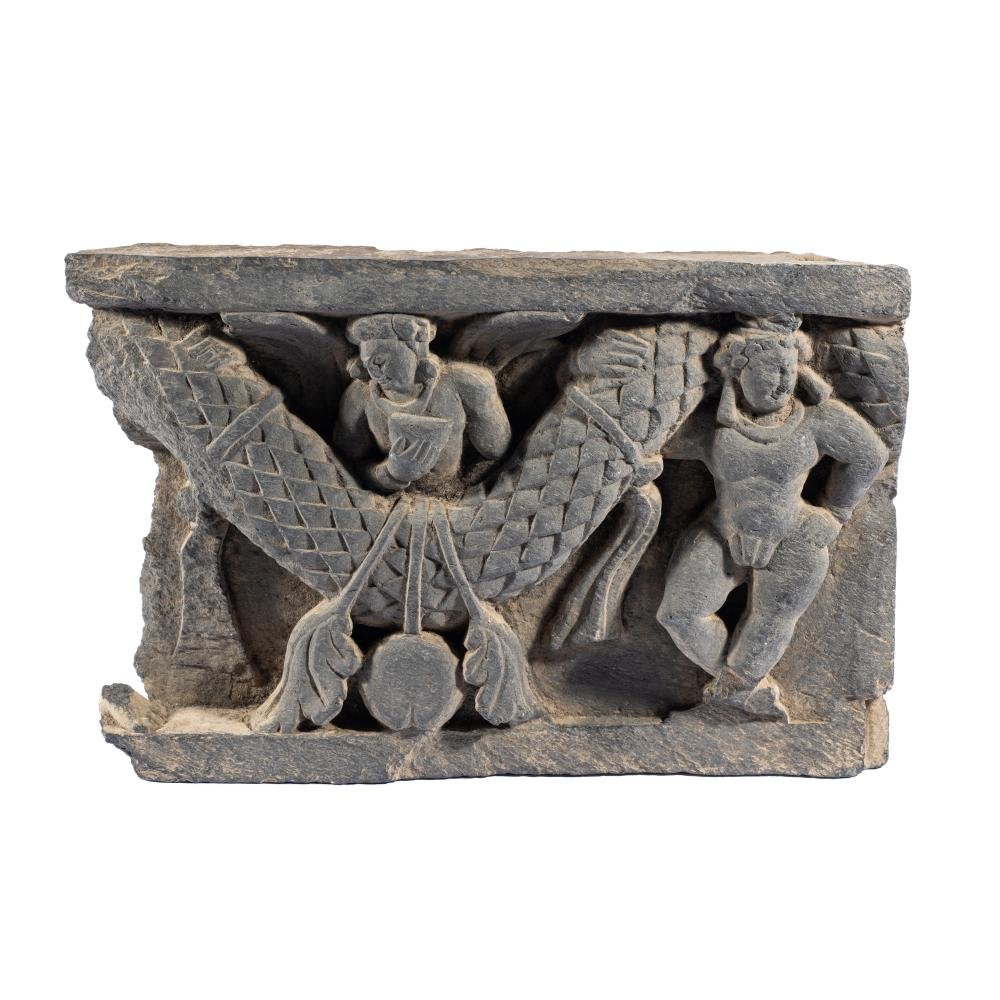 A Gandharan grey schist relief panel depicting two putti supporting a leafy garland weighed down by fruit. North-Western Pakistan, 300-400 C.E.