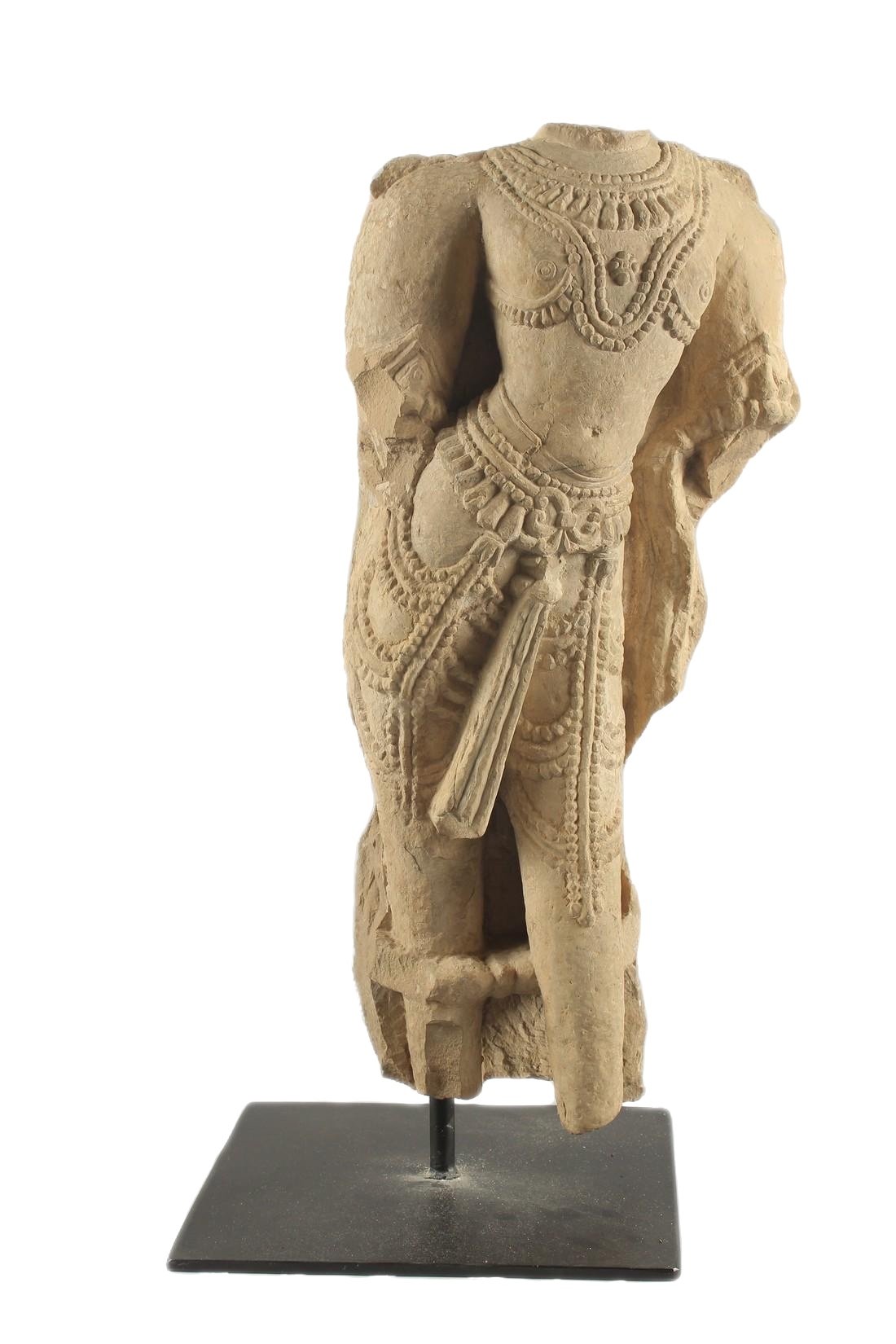 A fine large carved yellow stone torso of a female deity, the torso well decorated with beads and jewellery. Rajasthan, India, 11th century C.E.