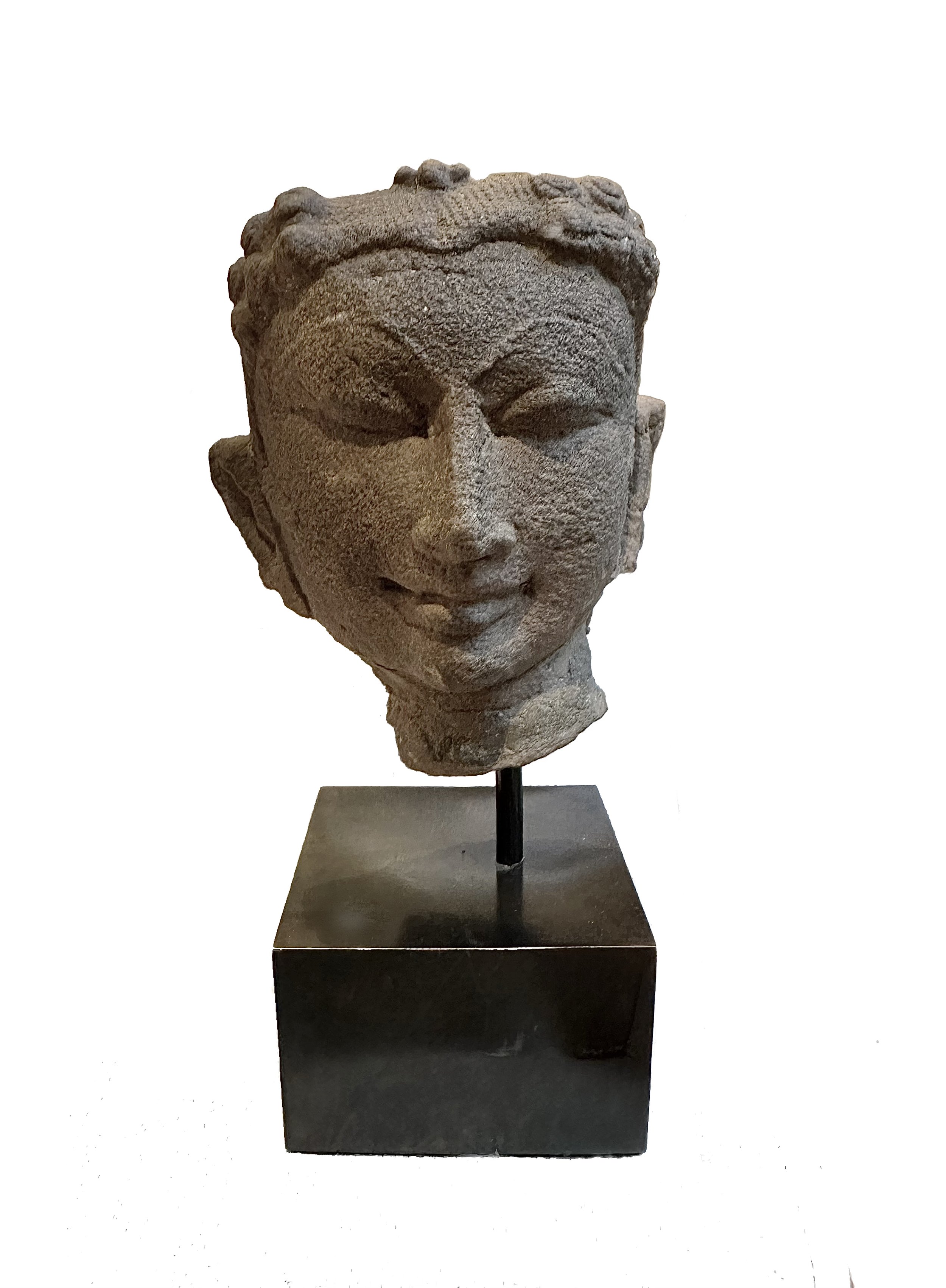 An Indian sandstone head of a male deity. 12-13th century C.E.
