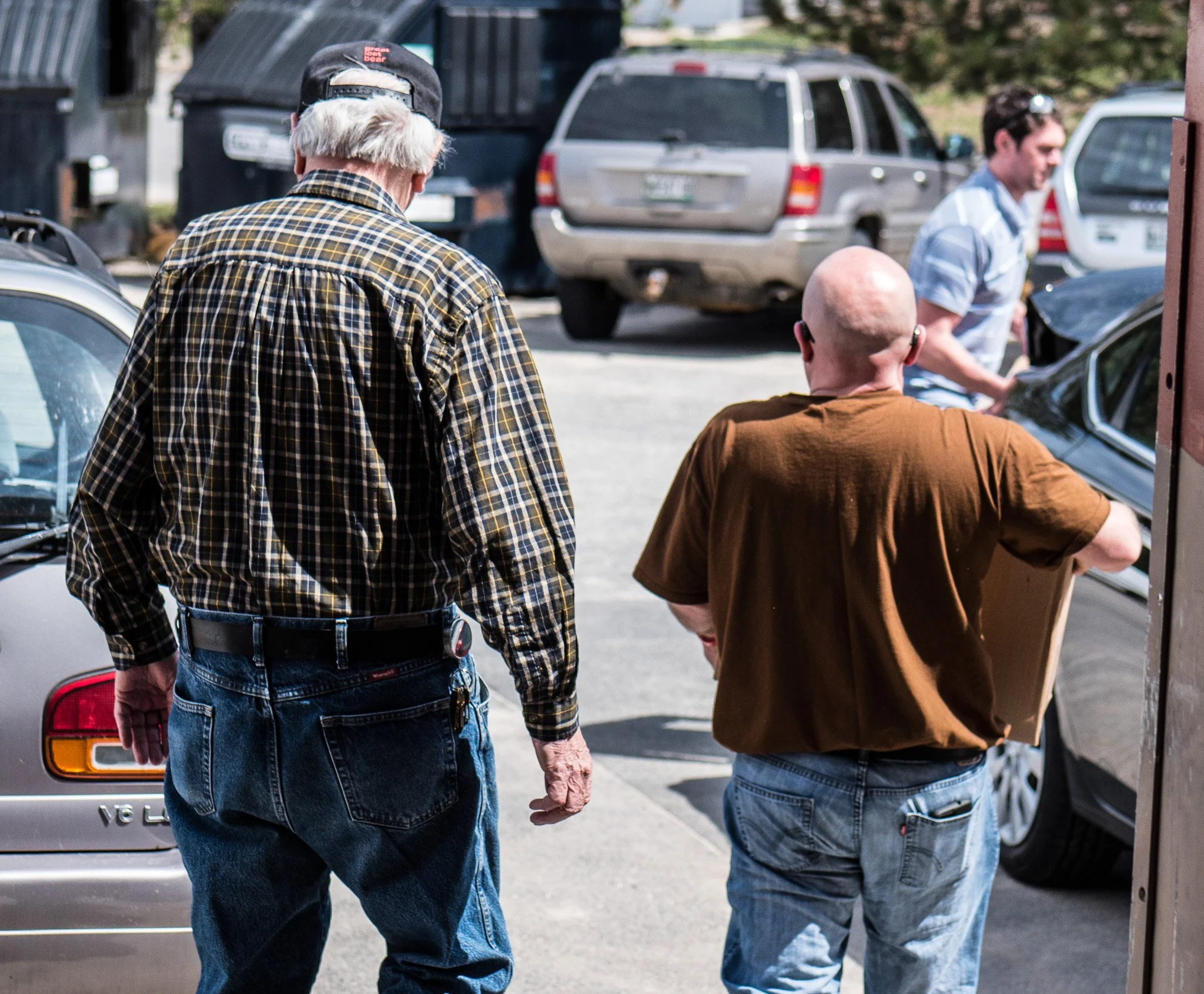 Two men walking in a parking lot