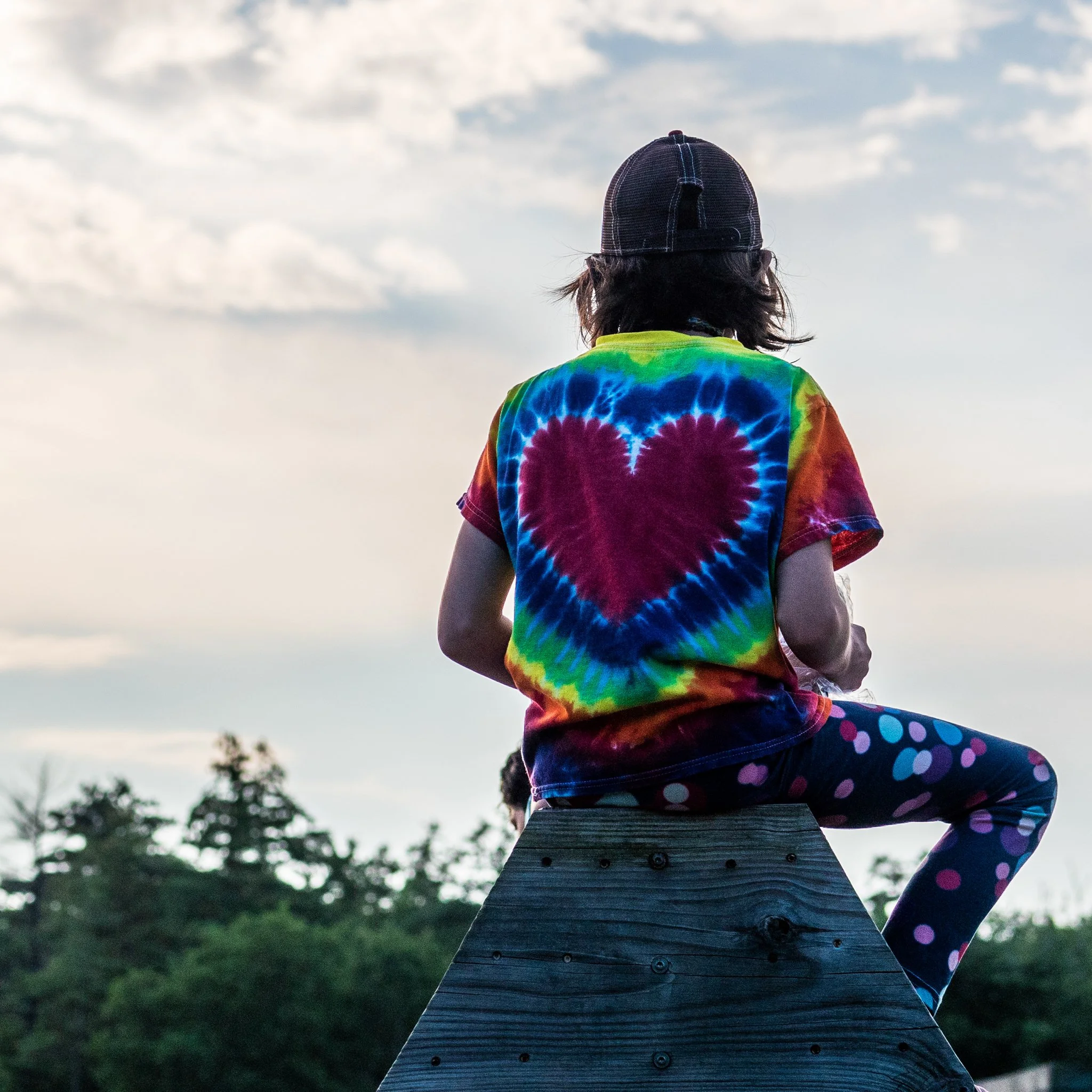 Kid sitting on adults shoulders
