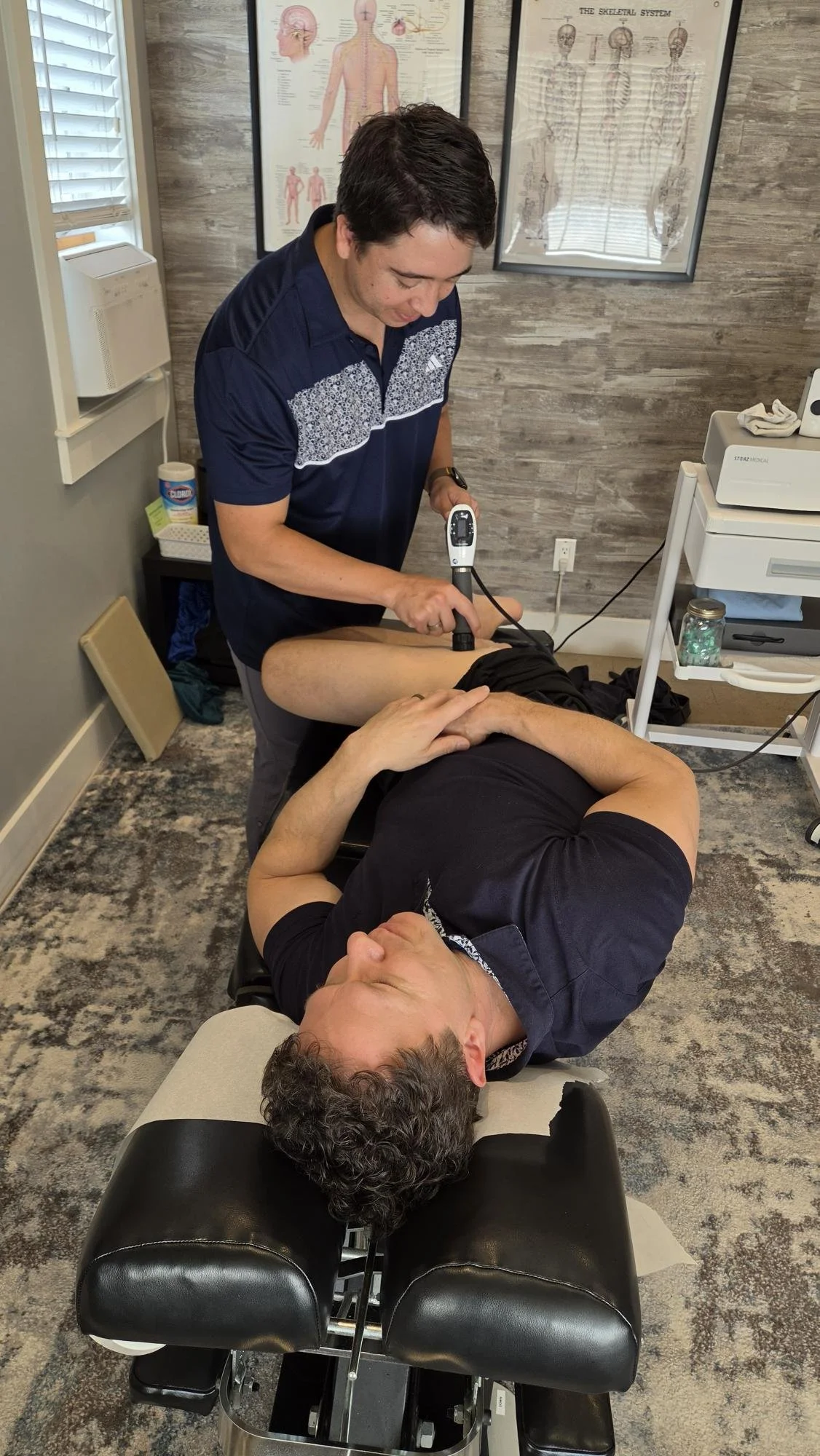 Dr. Josh Cordova giving Dr. Kevin Shockwave treatment in Cranbrook BC for hip pain.
