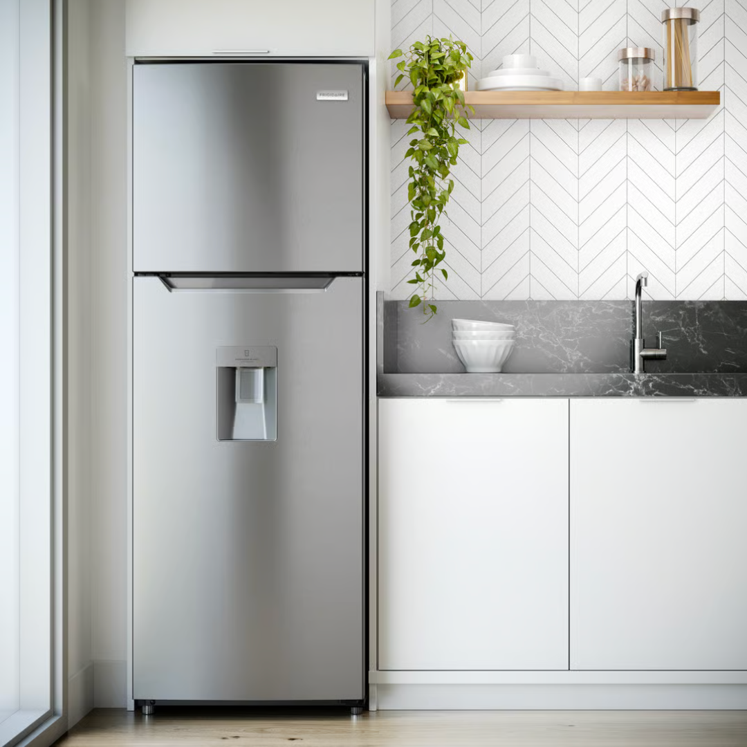 Moderne keuken met koelkast, gootsteen, witte kastjes, en open houten plank met thee- en koffietronken en decoratie.