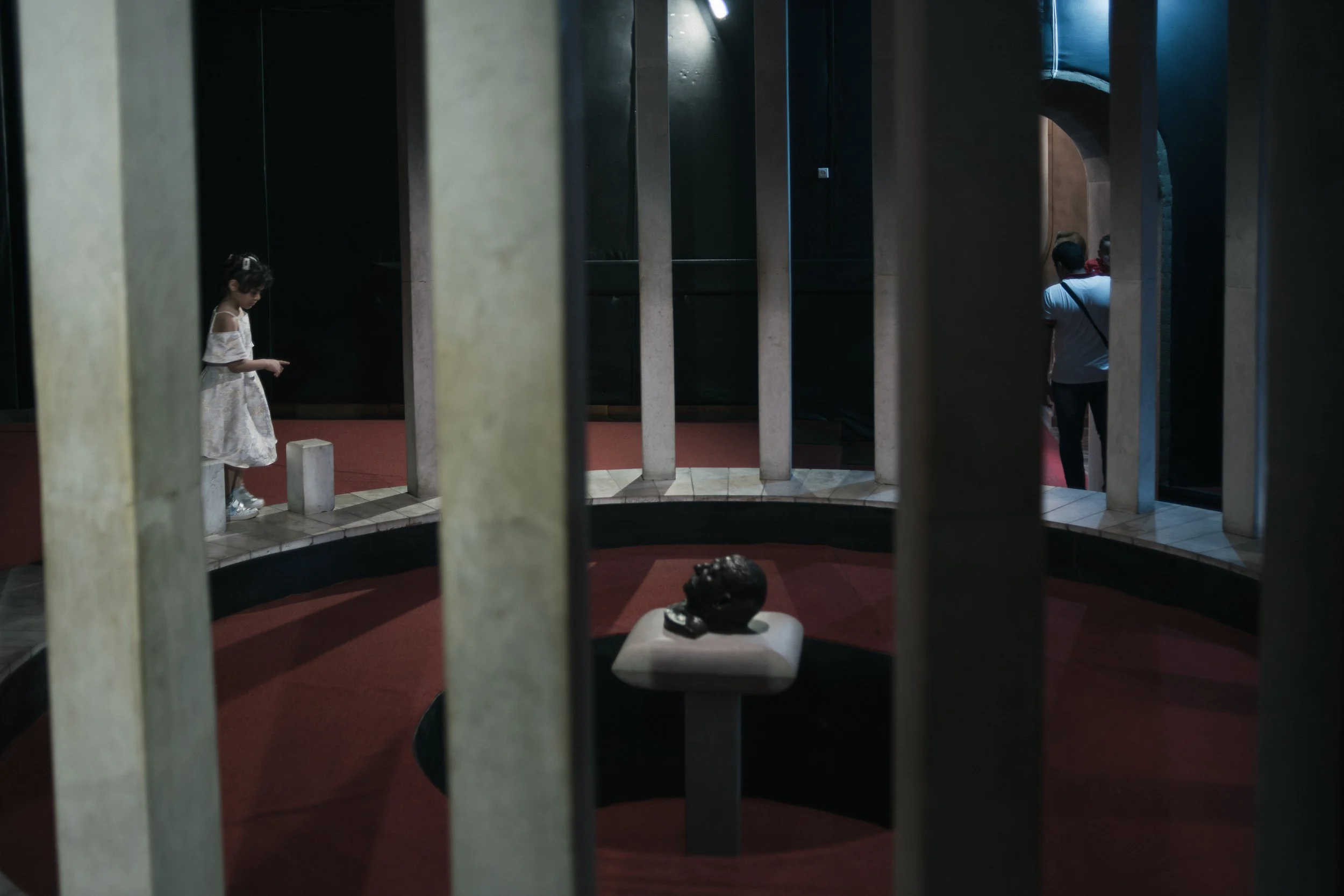 Gori. A child passes a death mask of Joseph Stalin at the Stalin Museum.