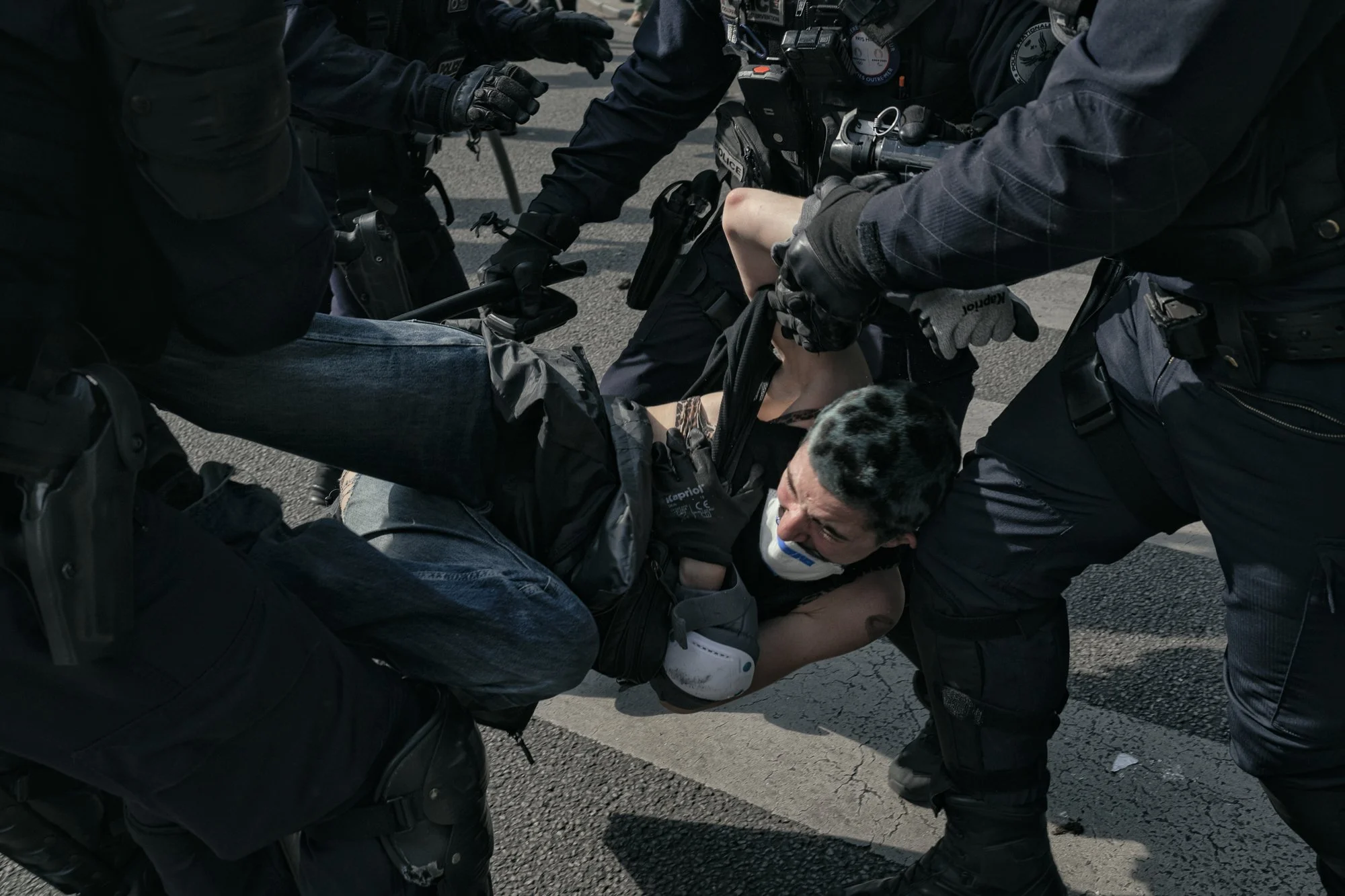 CRS Riot Police remove a protestor amidst clashes at the annual May Day demonstrations, Paris. May 2025