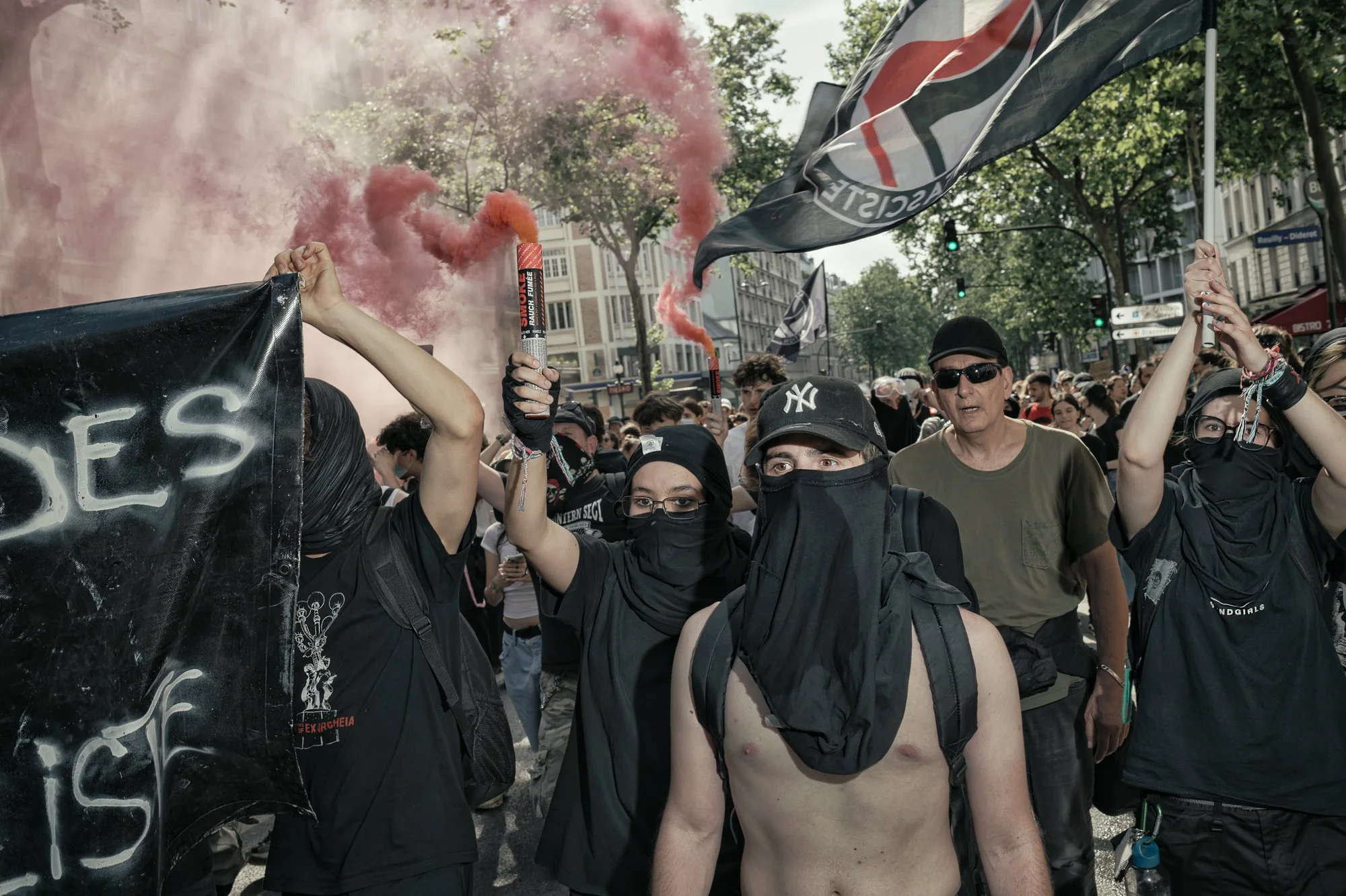 Antifa members light flares during annual May Day demonstrations, Paris. May 2025