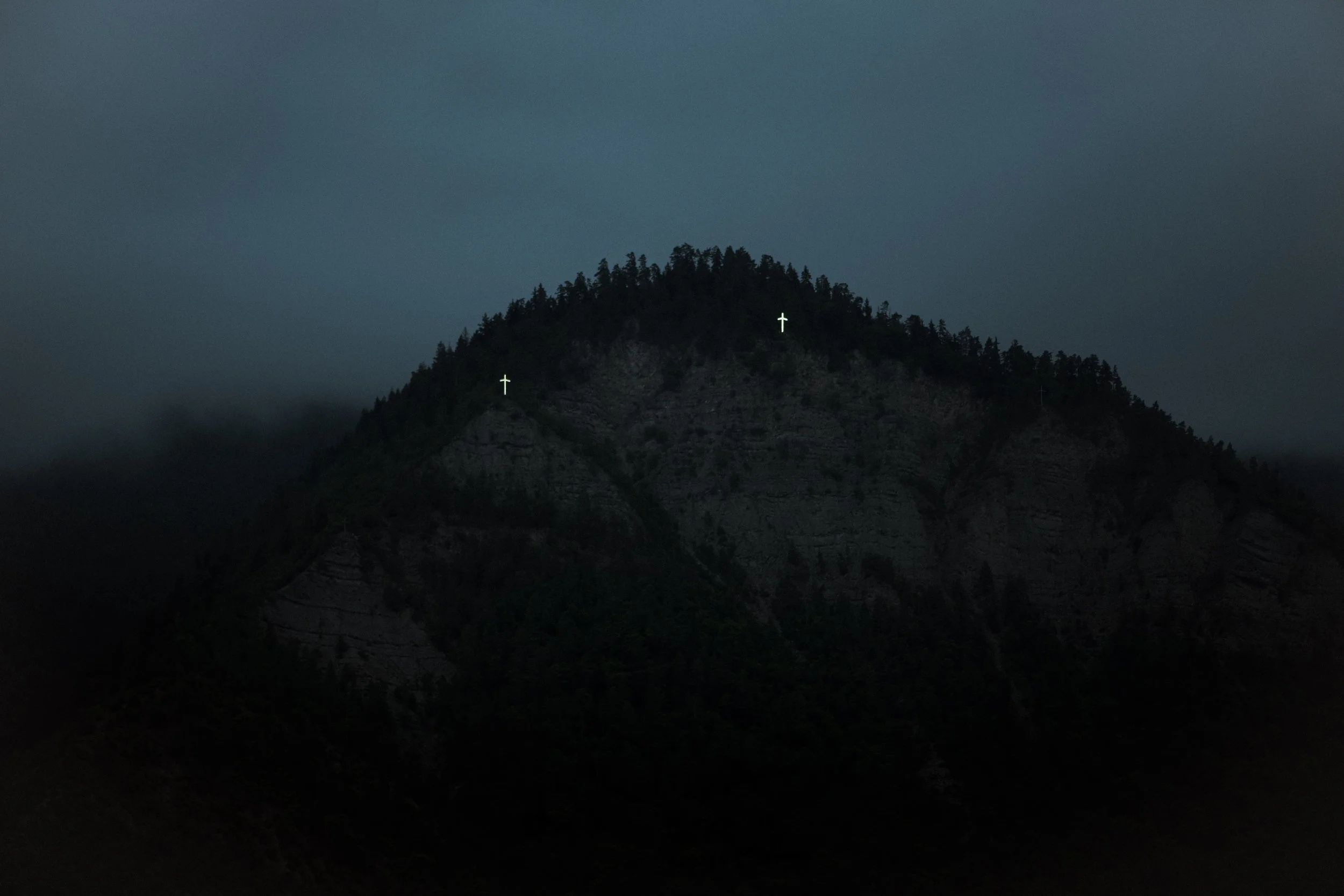 Cross Mountain, Borjomi.  Illuminated St. Nino’s grapevine crosses stand above the valley town, which operated as a premier network of state sanatoriums under Soviet rule.