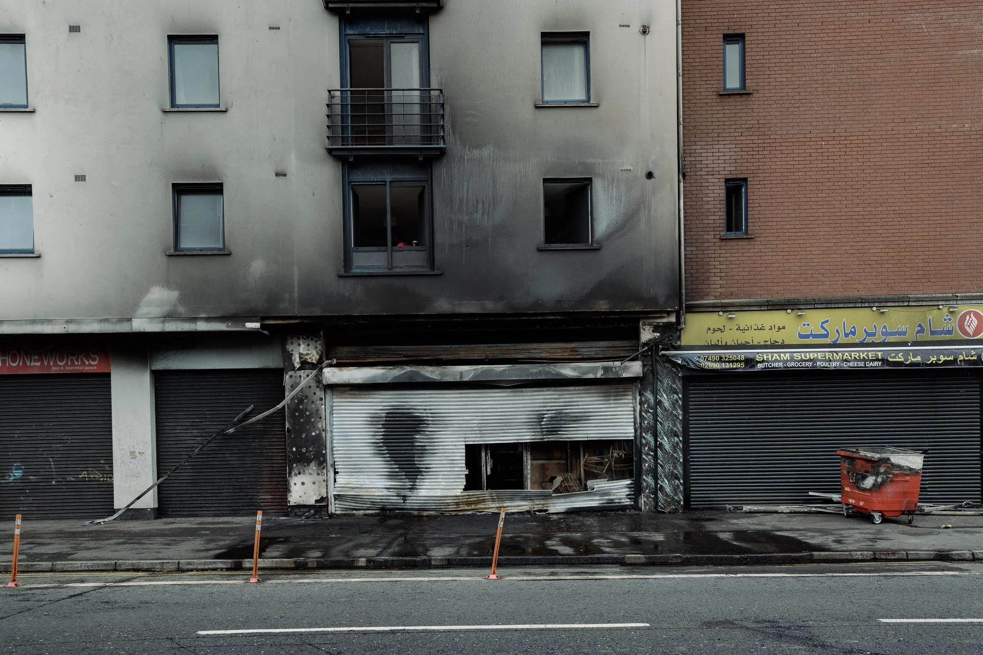 The burnt remains of the Syrian-owned Sham Supermarket after it was set alright. Belfast. 2026 