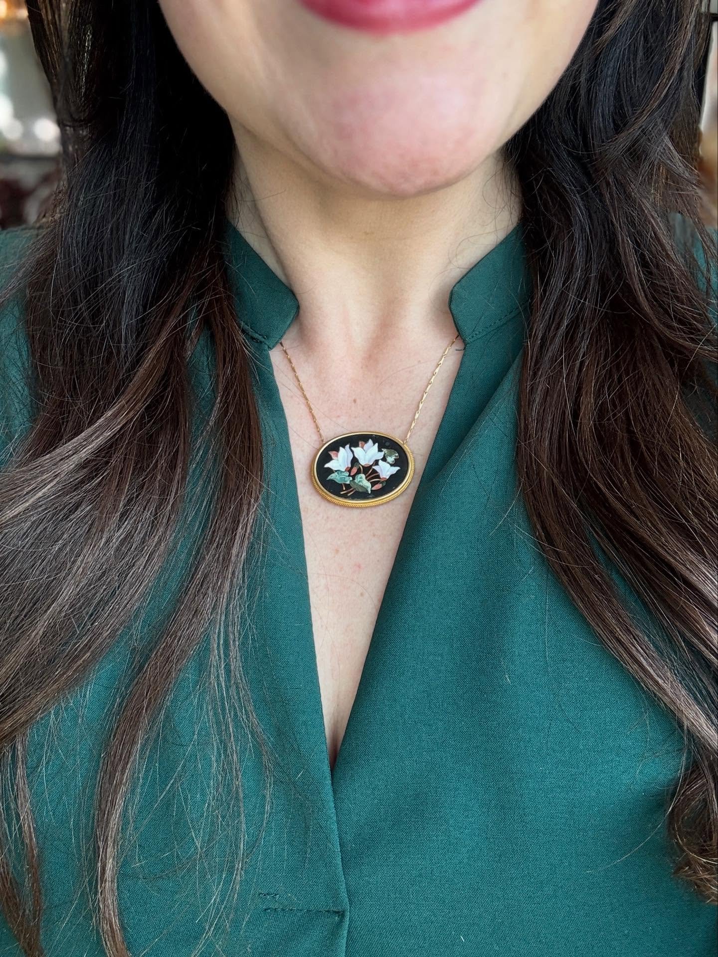 A blooming beauty from the Victorian era! 🌷 This captivating antique necklace, trimmed in 18k yellow gold, showcases a breathtaking micromosaic of cyclamen flowers. Originally a brooch, it was skillfully converted into this wearable piece of art. 
A