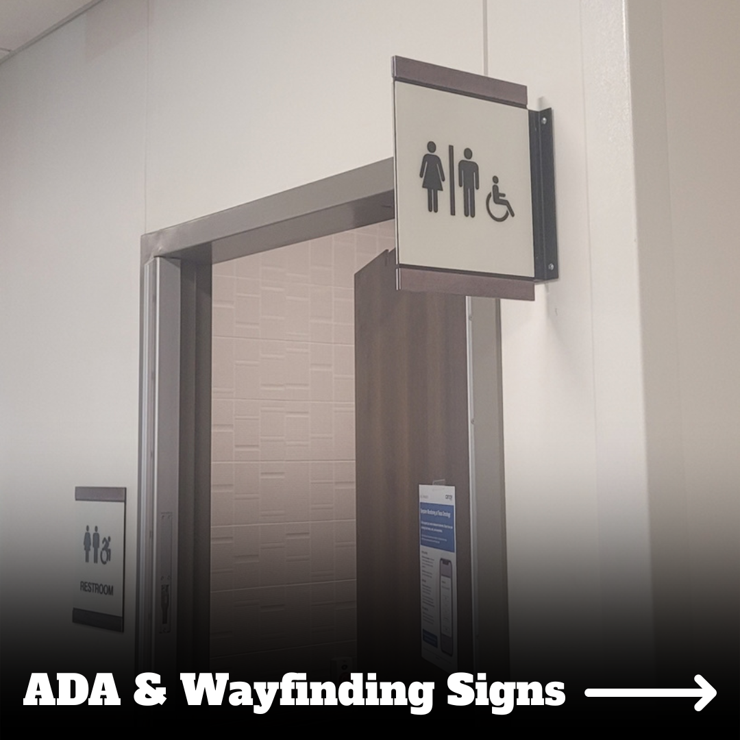 Restroom entrance with ADA access sign showing symbols for women, men, and wheelchair user.