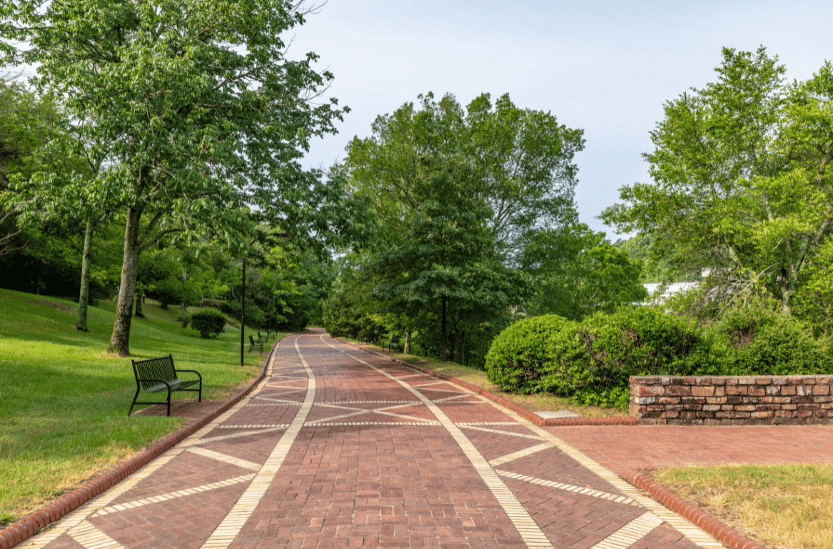 The Grand Promenade’s brick walking path, lined with stone walls and greenery overlooking Bathhouse Row in Hot Springs National Park.