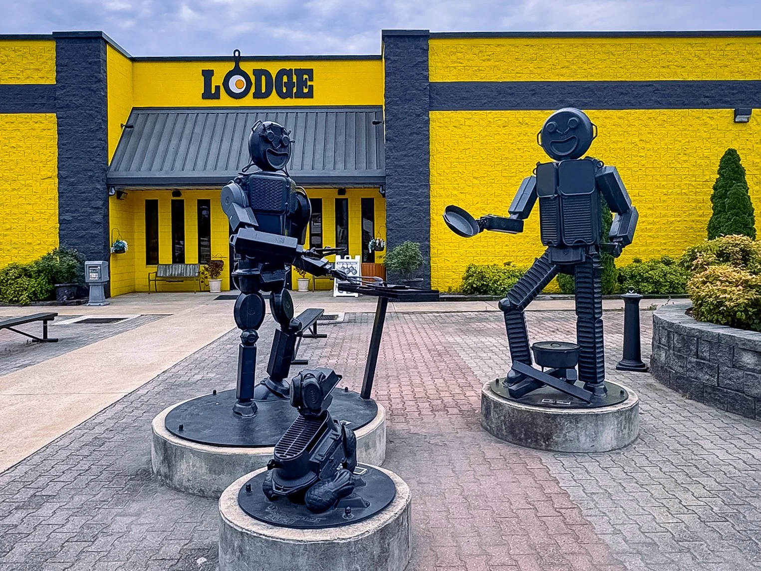Metal sculptures of a man, woman and dog made from cast iron skillets and cookware stand outside the Lodge Museum of Cast Iron in South Pittsburg, Tennessee.