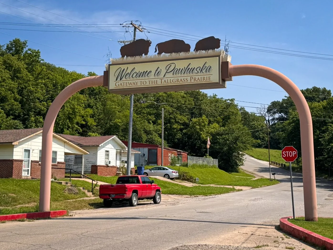 A archway stretching across Kihekah Avenue in Pawhuska, Oklahoma, has a sign that reads: Welcome to Pawhuska, gateway to the tallgrass prairie.