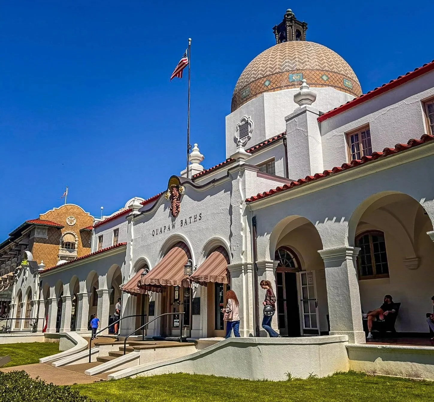 Exterior of Quapaw Baths & Spa showing its tiled dome and Spanish Colonial Revival architecture on Bathhouse Row.