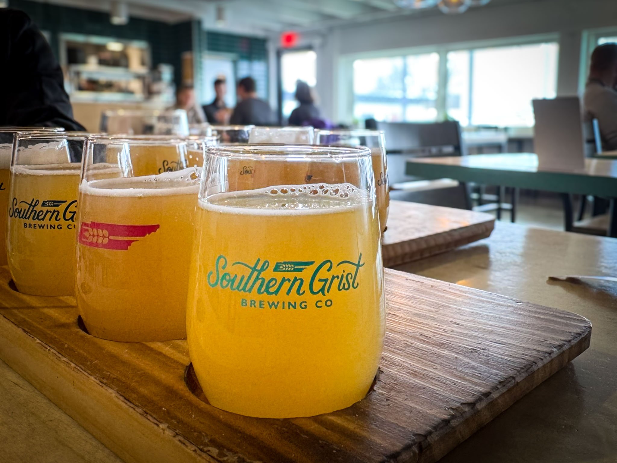 Tasting glasses bearing the Southern Grist Brewing Co. logo are filled with hazy IPA at the brewery’s location in East Nashville.