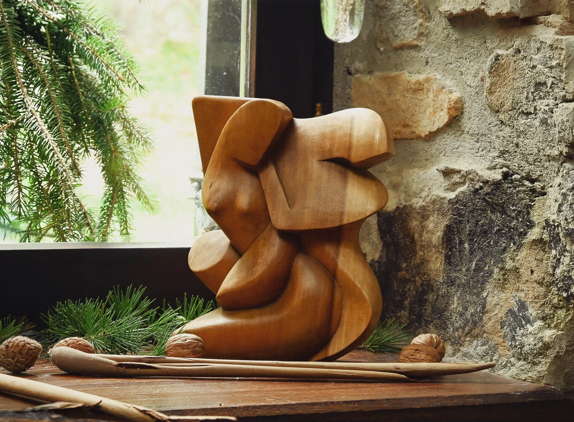 Wooden sculptures, often created by anonymous artists, bring organic forms and raw textures into a space. They carry a quiet, something deeply rooted and timeless.