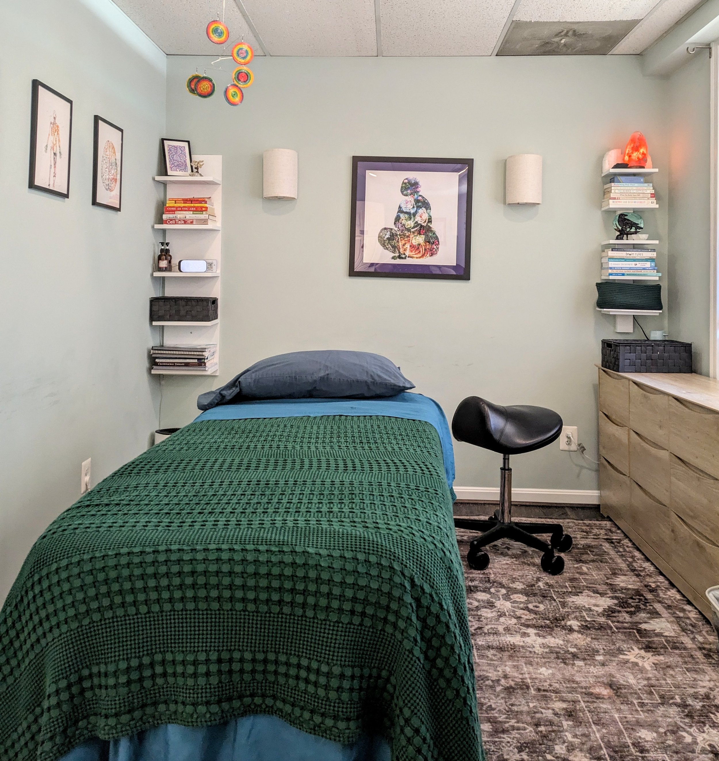 Treatment table has extra padding, extra width, high weight capacity, and goes up and down so you can lie down easily