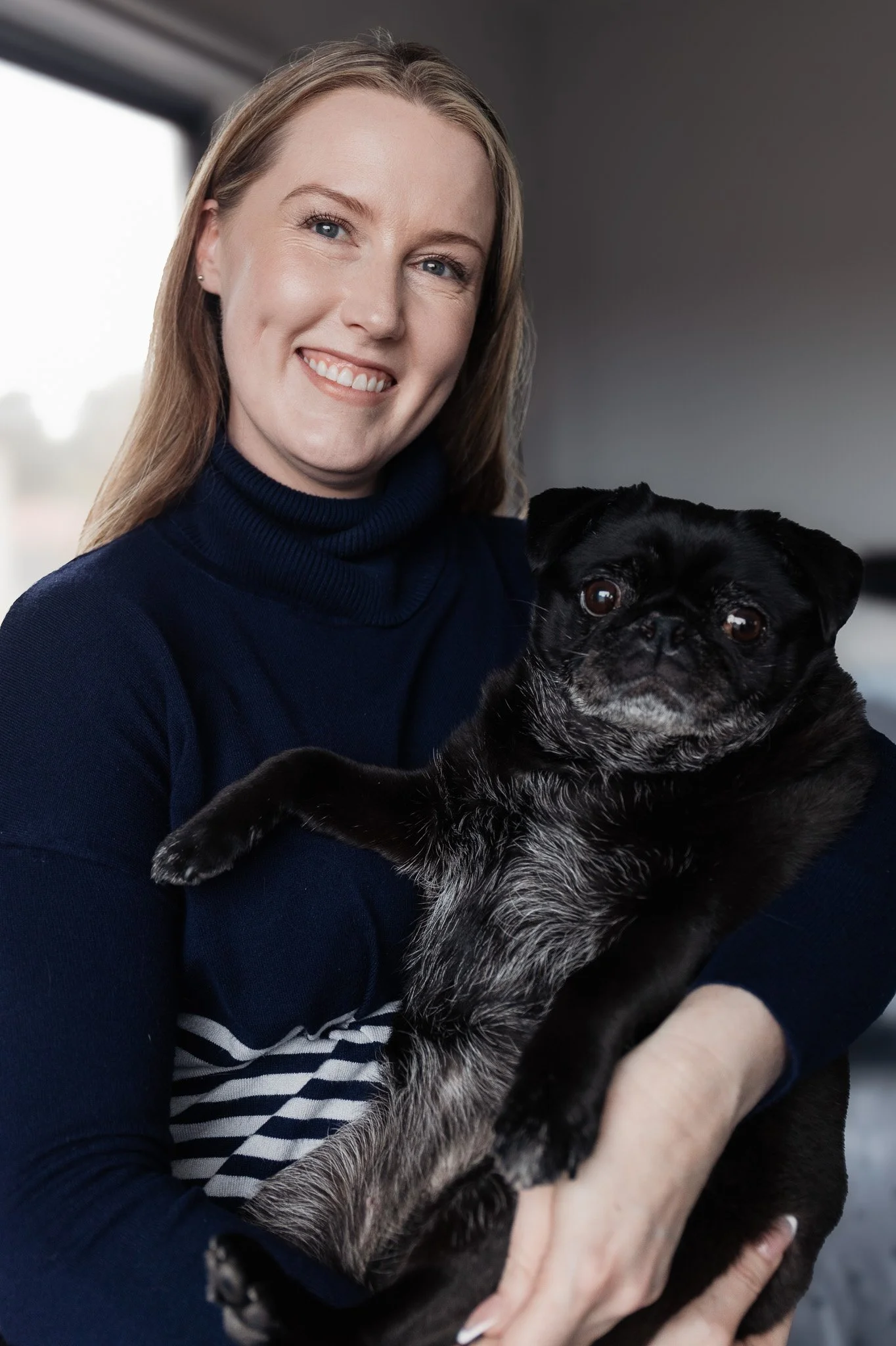 KK Stanley, A woman with Brown hair with blonde foils and holding her dog