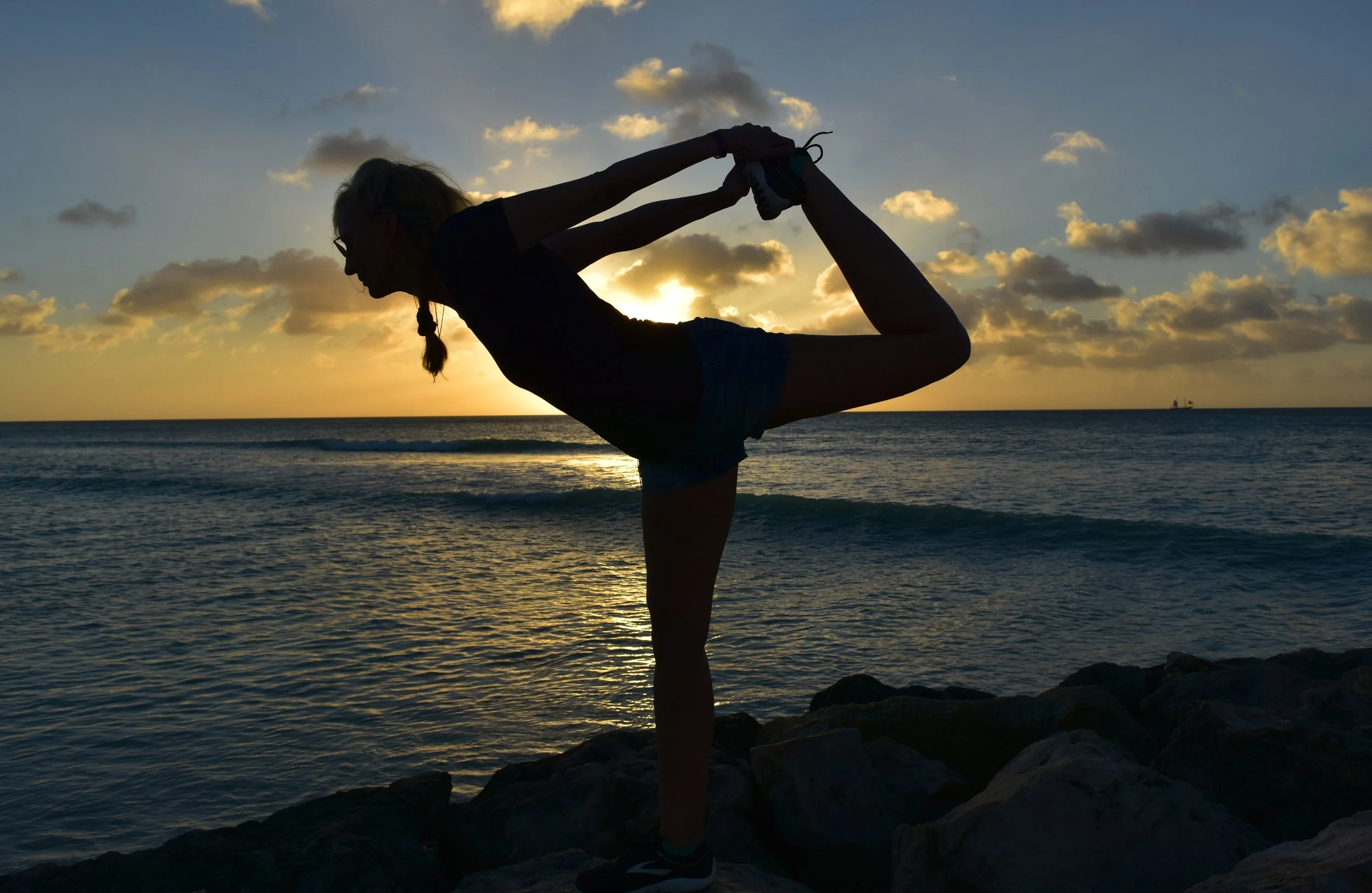 yoga-dancer-pose-silhouetted-as-sun-is-setting-against-sky.jpg