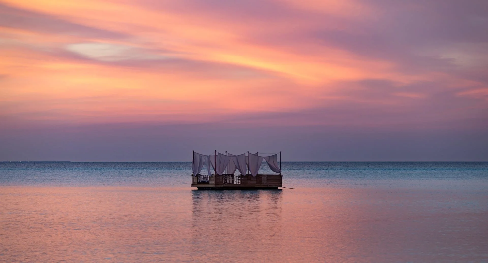 anantara_dhigu_dining_by_design_floating_sunset_1920x1037.jpg