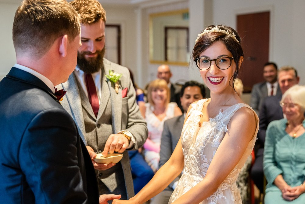 Bride waiting for her wedding ring to go on at Hillingdon Registry Office