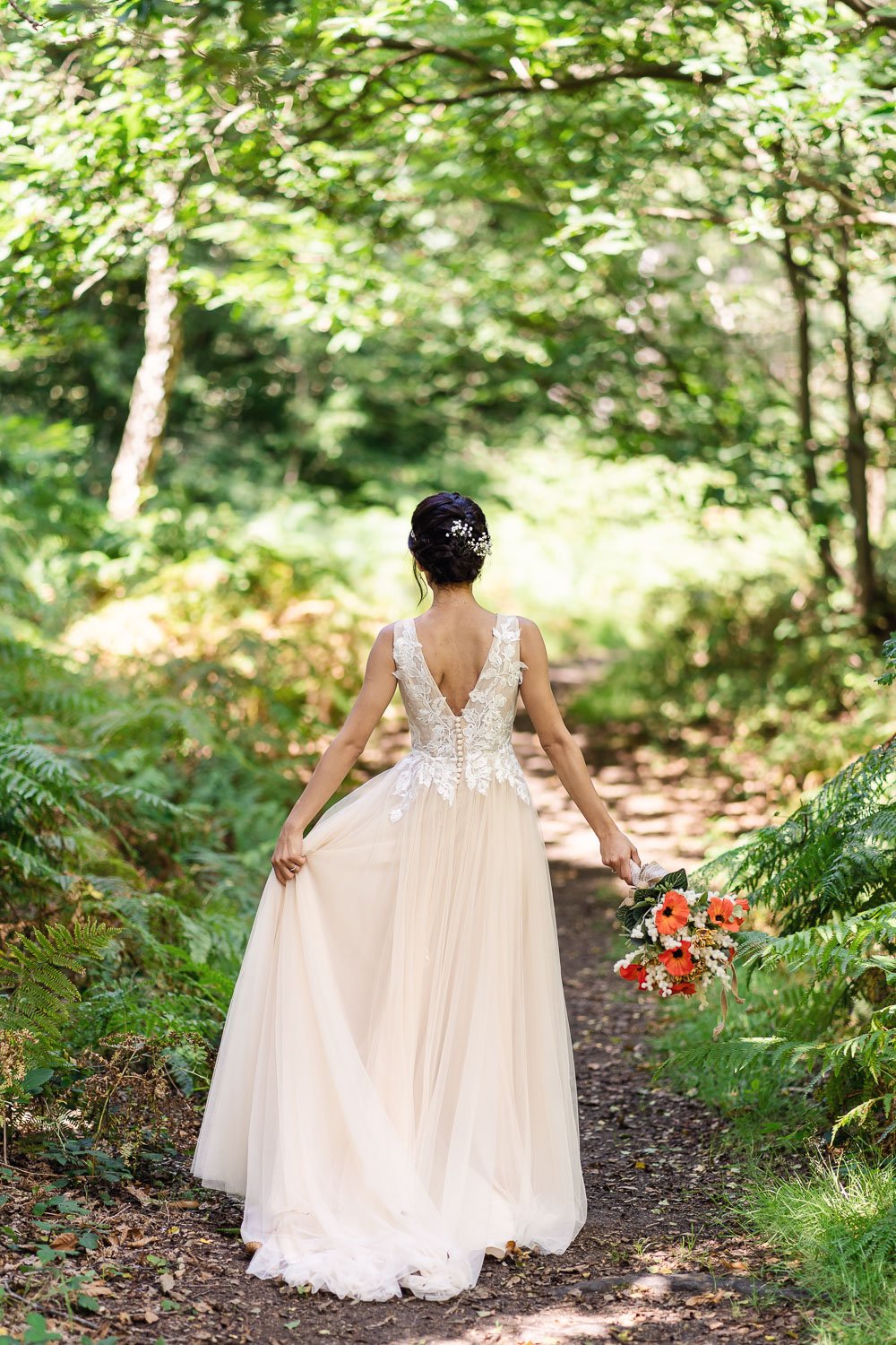 bride fans out her dress in ruislip woods