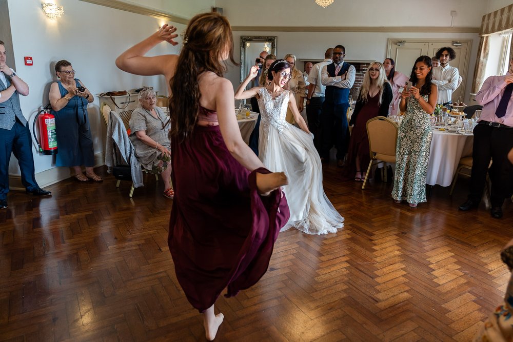 bride and bridesmaid dance routine at Eastcote wedding