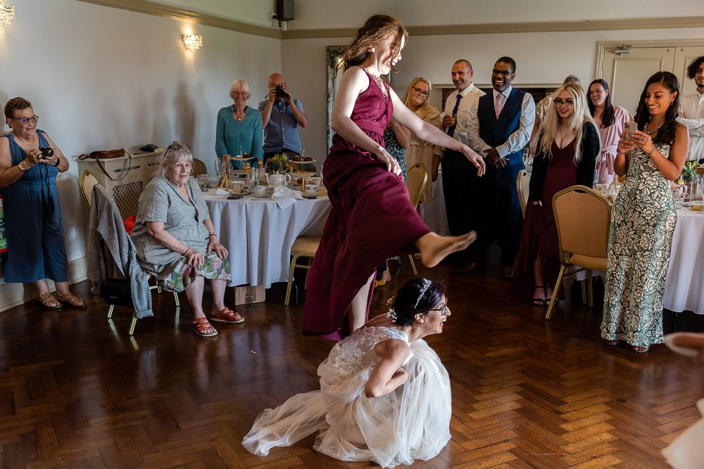 bridesmaid jumps over the bride during first dance