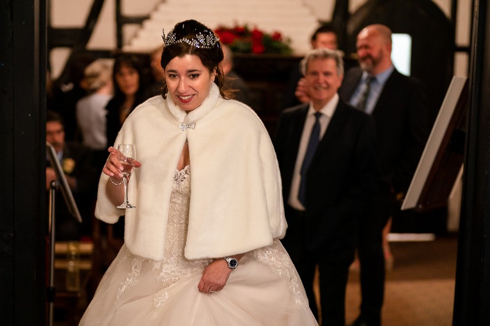 Bride enjoys champagne at her Ruislip wedding