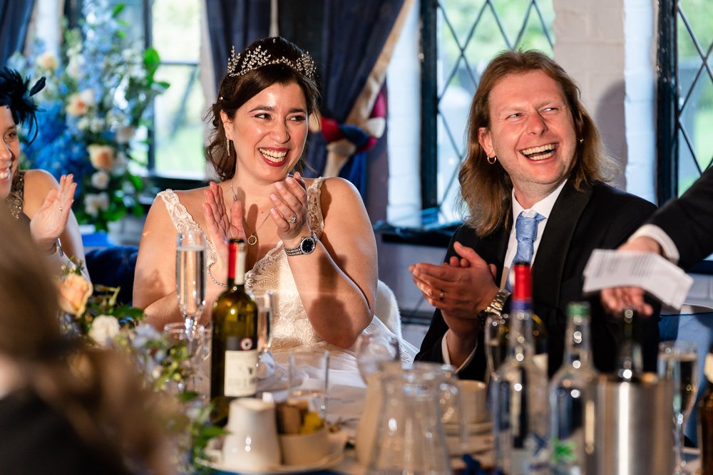 Newlyweds laugh at speeches at The Old Barn, Ruislip