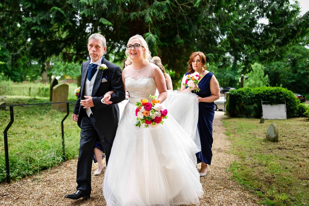 Bride and her father arrive at church for her Hampshire wedding 