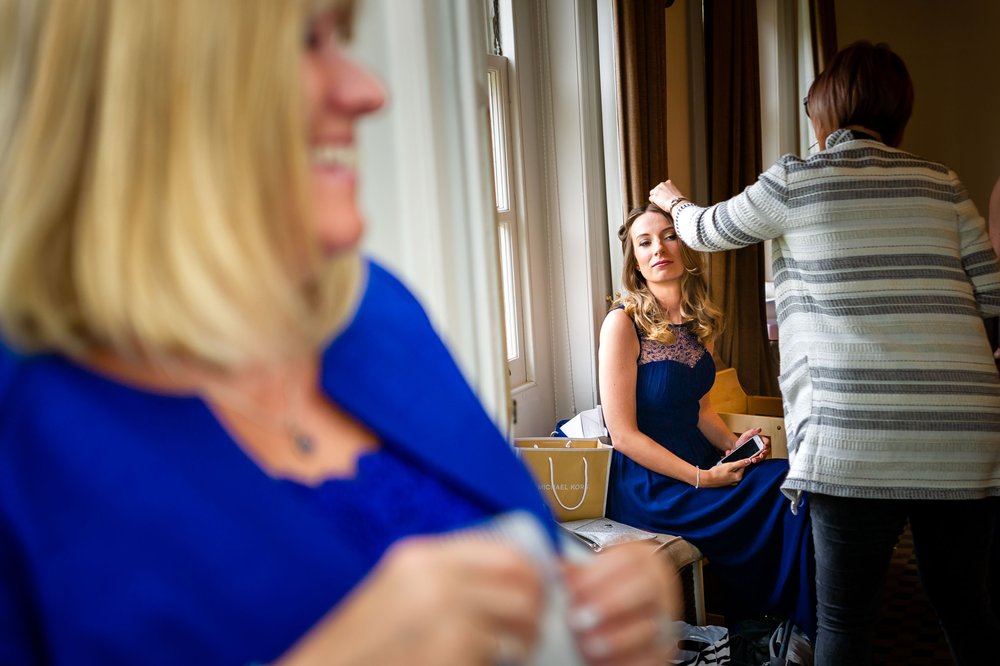 Bridesmaid gets the final touches to her hair