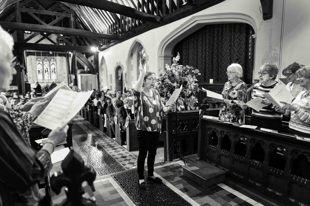 A choir sings in church during a Hampshire wedding