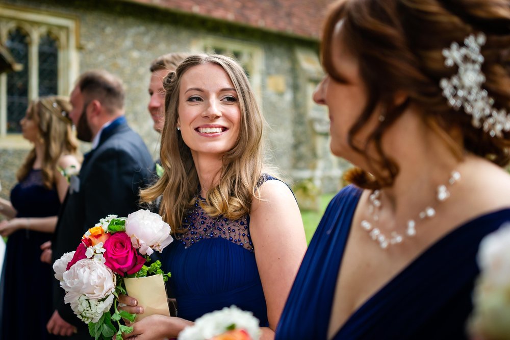 Bridesmaid awaiting the confetti at a Hampshire wedding