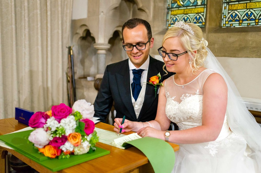 Bride and Groom sign the marriage registry in Hampshire