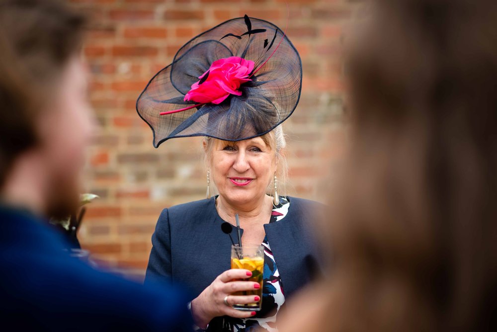 Wedding guest in pink and blue hat