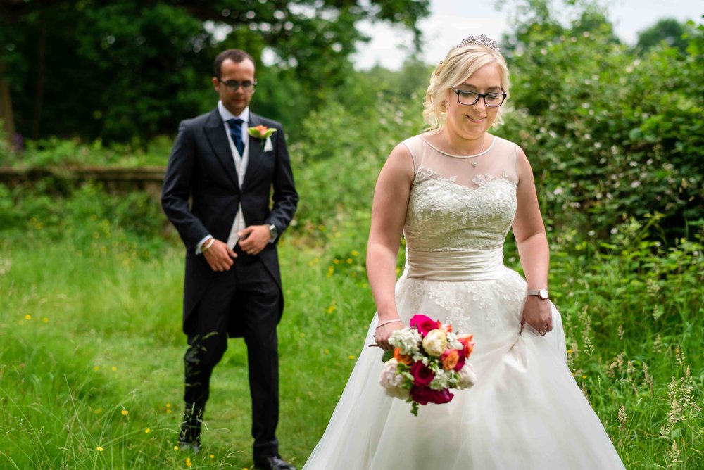 Wedding couple walk in the woods of Warbrook House