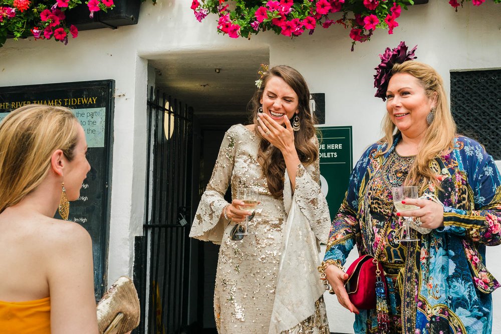 Holly Tucker MBE laughs with bride outside Richmond pub