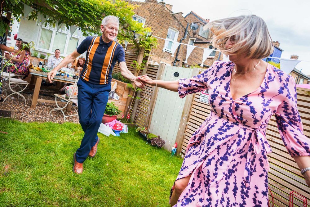 Jiving couple at garden wedding reception in Twickenham