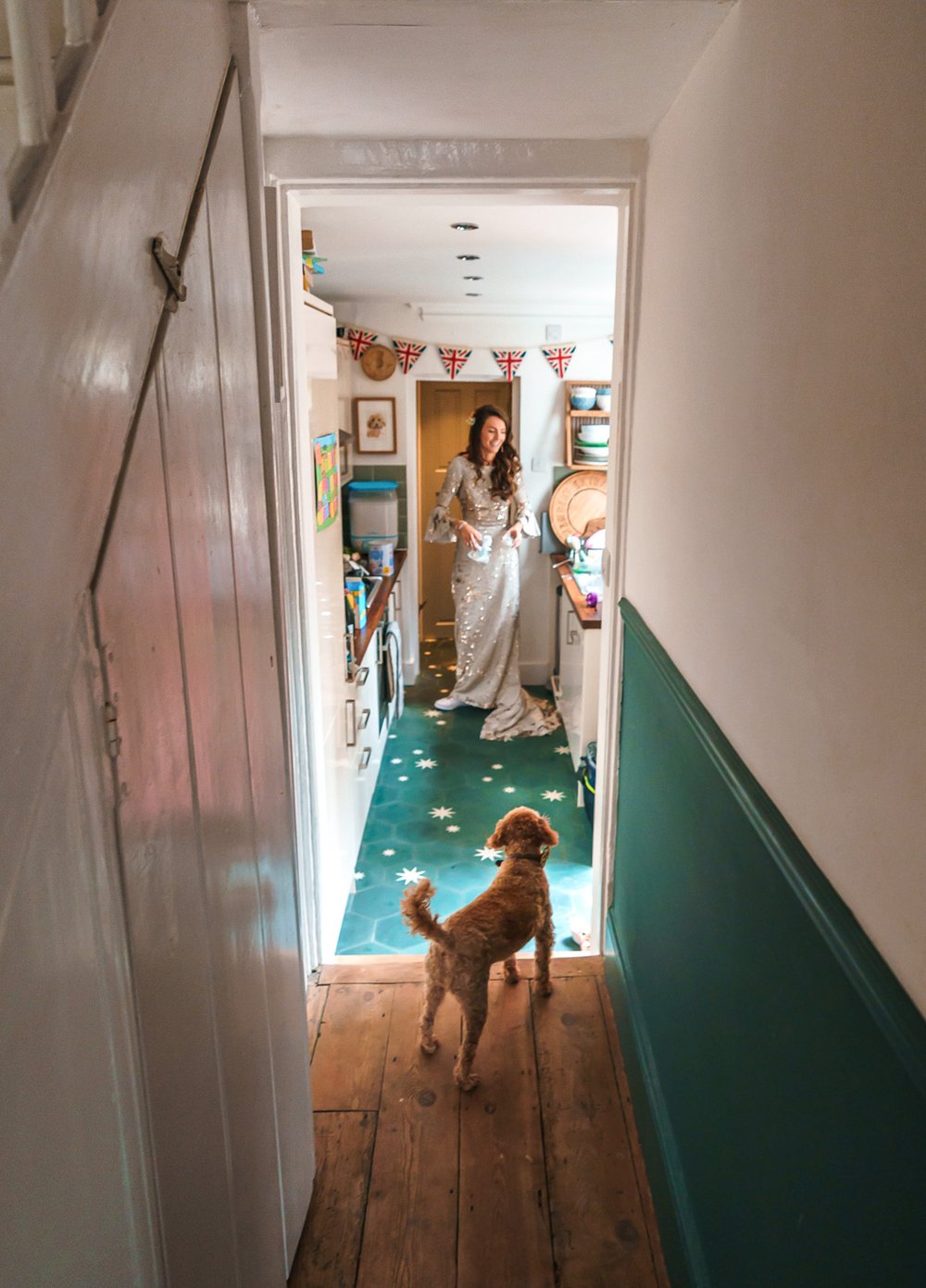 Toy poodle watches Twickenham bride in kitchen 