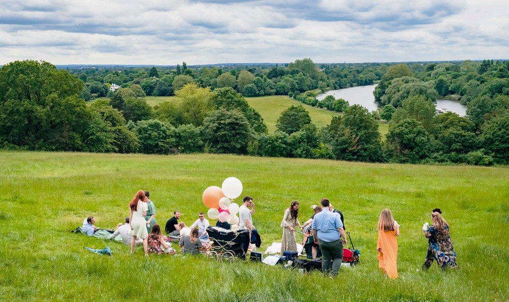 Wedding guests enjoy a picnic on Richmond Hill