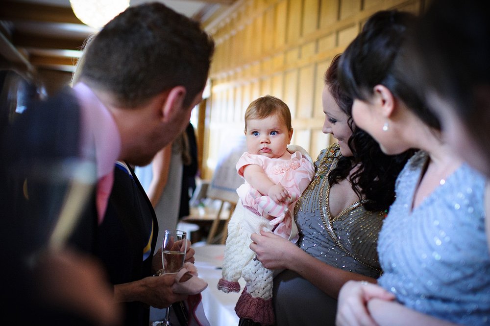 Baby stares at Coombe Lodge wedding guests