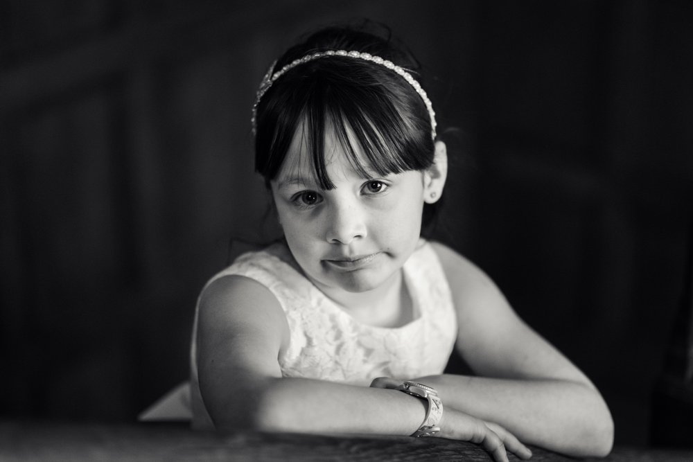 Girl poses for the camera during Coombe Lodge wedding reception