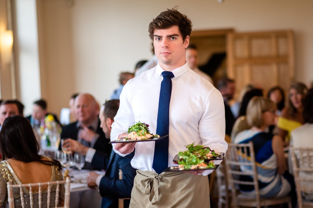 Waiter with first course at Coombe Lodge wedding, Blagdon