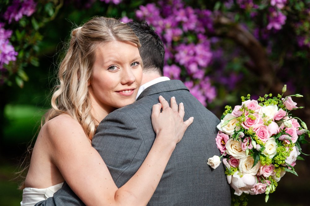 Bride with bouquet at Donnington Valley Hotel, Newbury