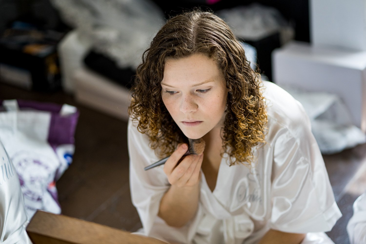 Bridesmaid applies makeup at The Olde Bell, Hurley