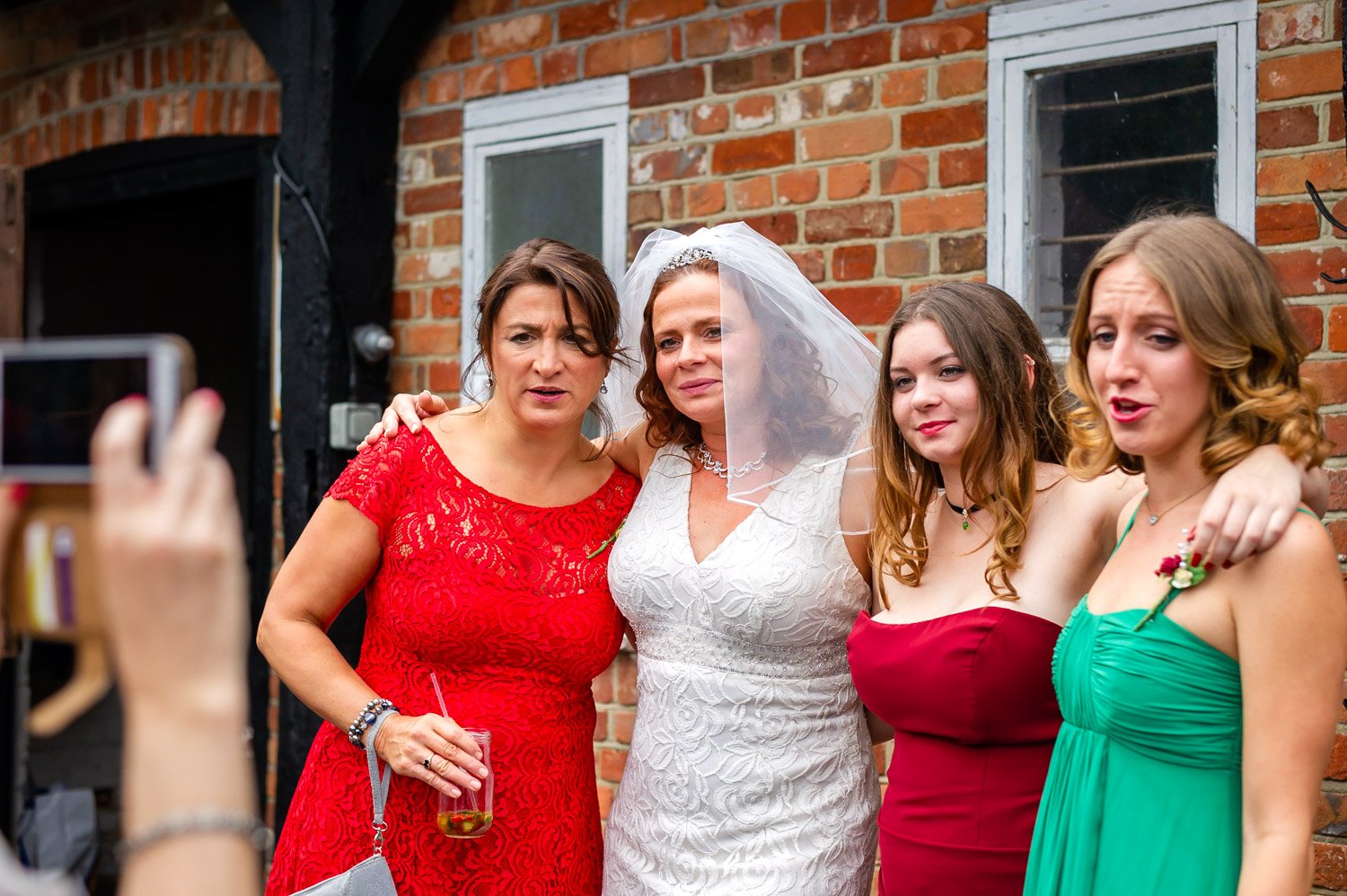Bride and friends pose for phone photo at Herons Farm